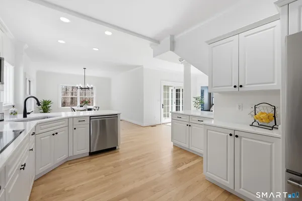 a kitchen with stainless steel appliances a refrigerator sink and cabinets