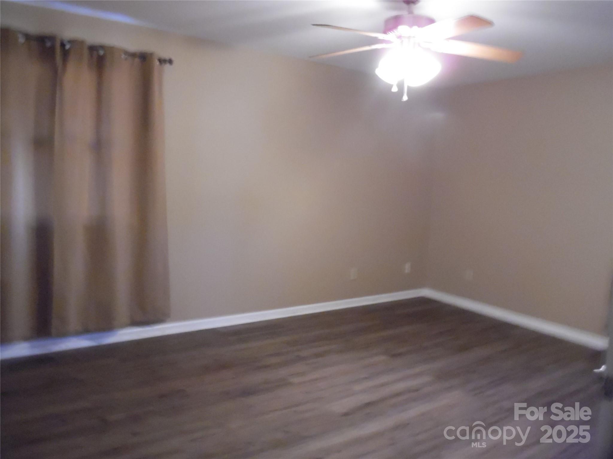 3857 Buffalo Shoals Road Maiden, NC 28650 - Photo 24 of 27 a view of an empty room with wooden floor and fan