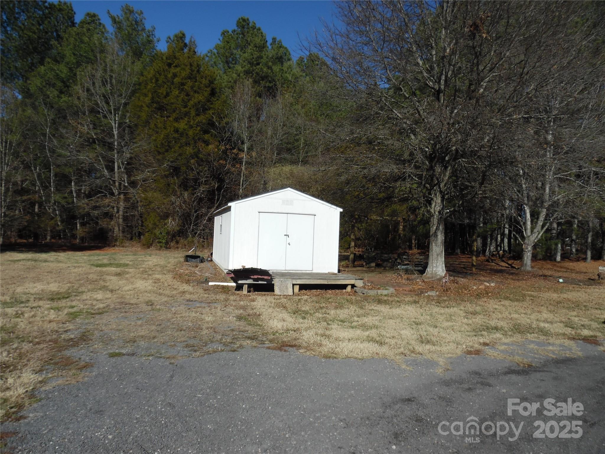 3857 Buffalo Shoals Road Maiden, NC 28650 - Photo 6 of 27 a backyard of a house with a large tree