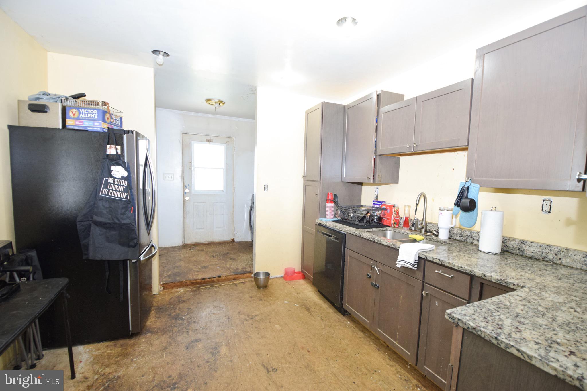2707 McComas Avenue Baltimore, MD 21222 - Photo 12 of 31 a kitchen with granite countertop a sink stove and cabinets