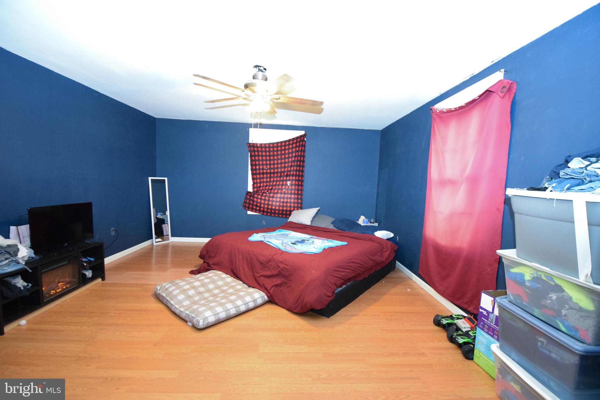2707 McComas Avenue Baltimore, MD 21222 - Photo 7 of 31 a bedroom with a bed and a chandelier