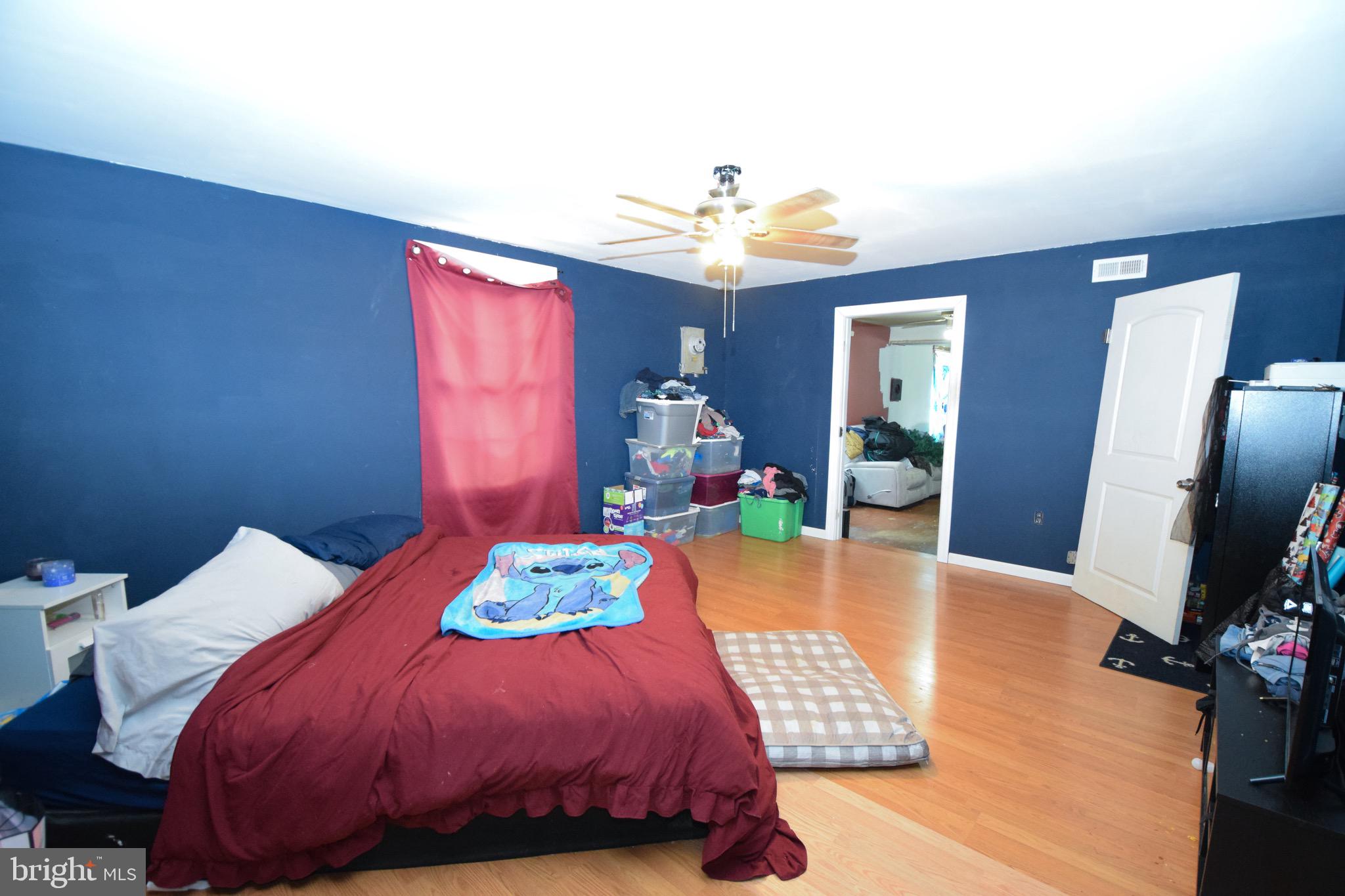 2707 McComas Avenue Baltimore, MD 21222 - Photo 8 of 31 a bedroom with a bed and a chandelier