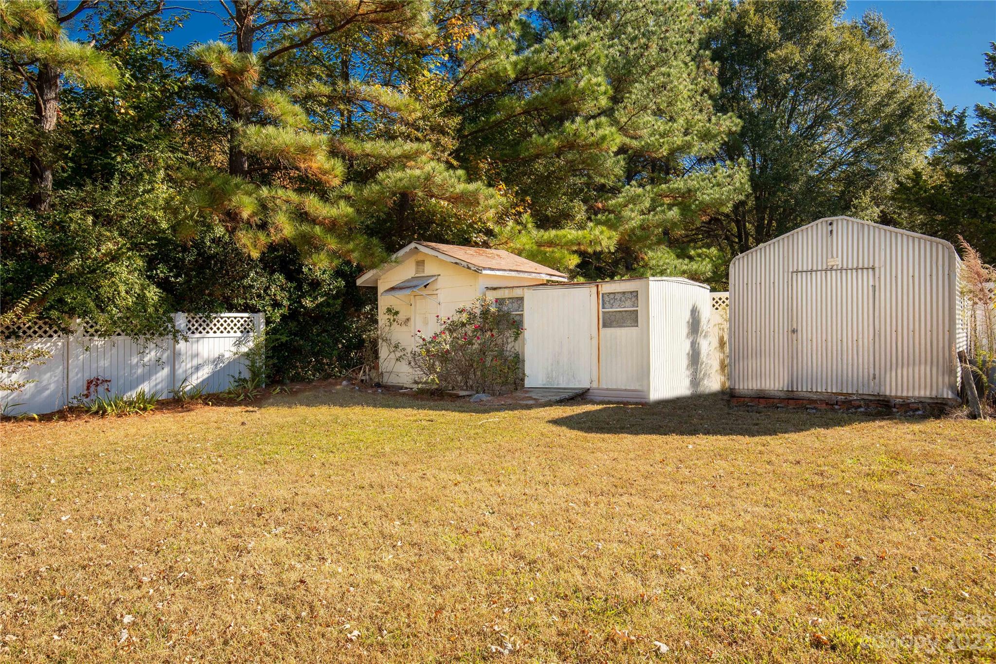 144 State Rd S-46-422 Clover, SC 29710 - Photo 22 of 23 a backyard of house with garage and wooden fence