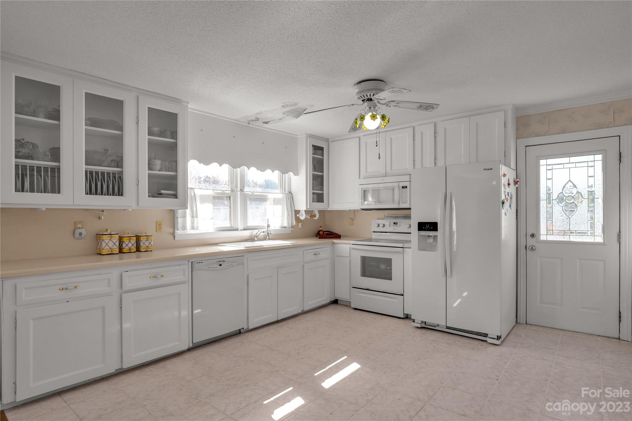 144 State Rd S-46-422 Clover, SC 29710 - Photo 3 of 23 a kitchen with white cabinets and white appliances