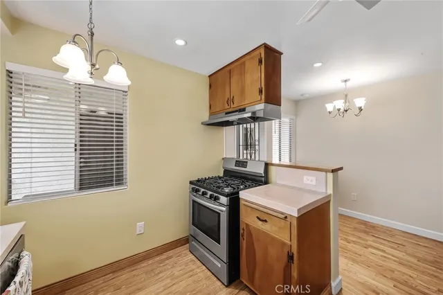 a utility room with wooden floor washer and dryer