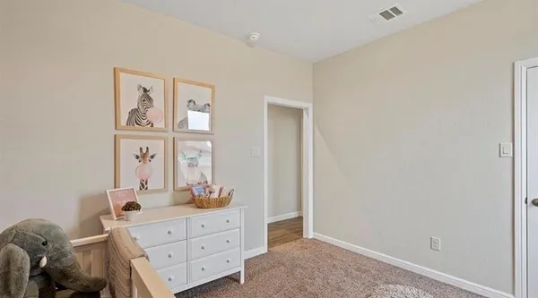a bedroom with a baby crib and a window