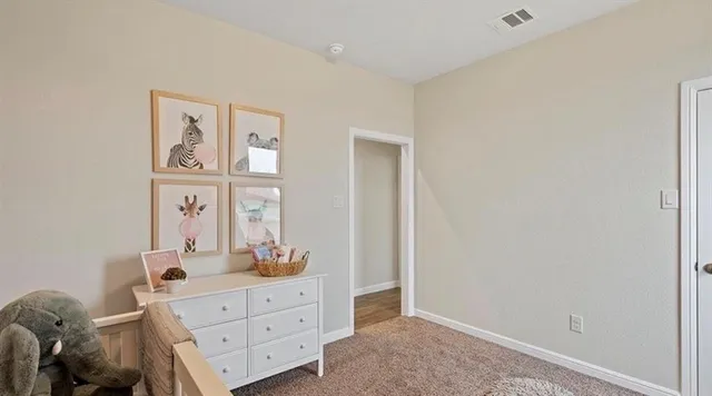 a bedroom with a baby crib and a window