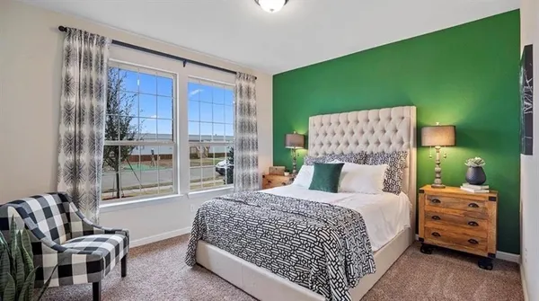 a bedroom with a large bed and a chandelier