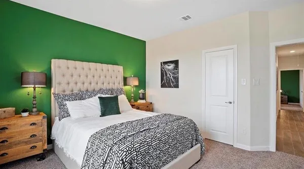 a bedroom with a bed and large windows