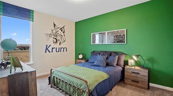 a bedroom with a large bed and a window