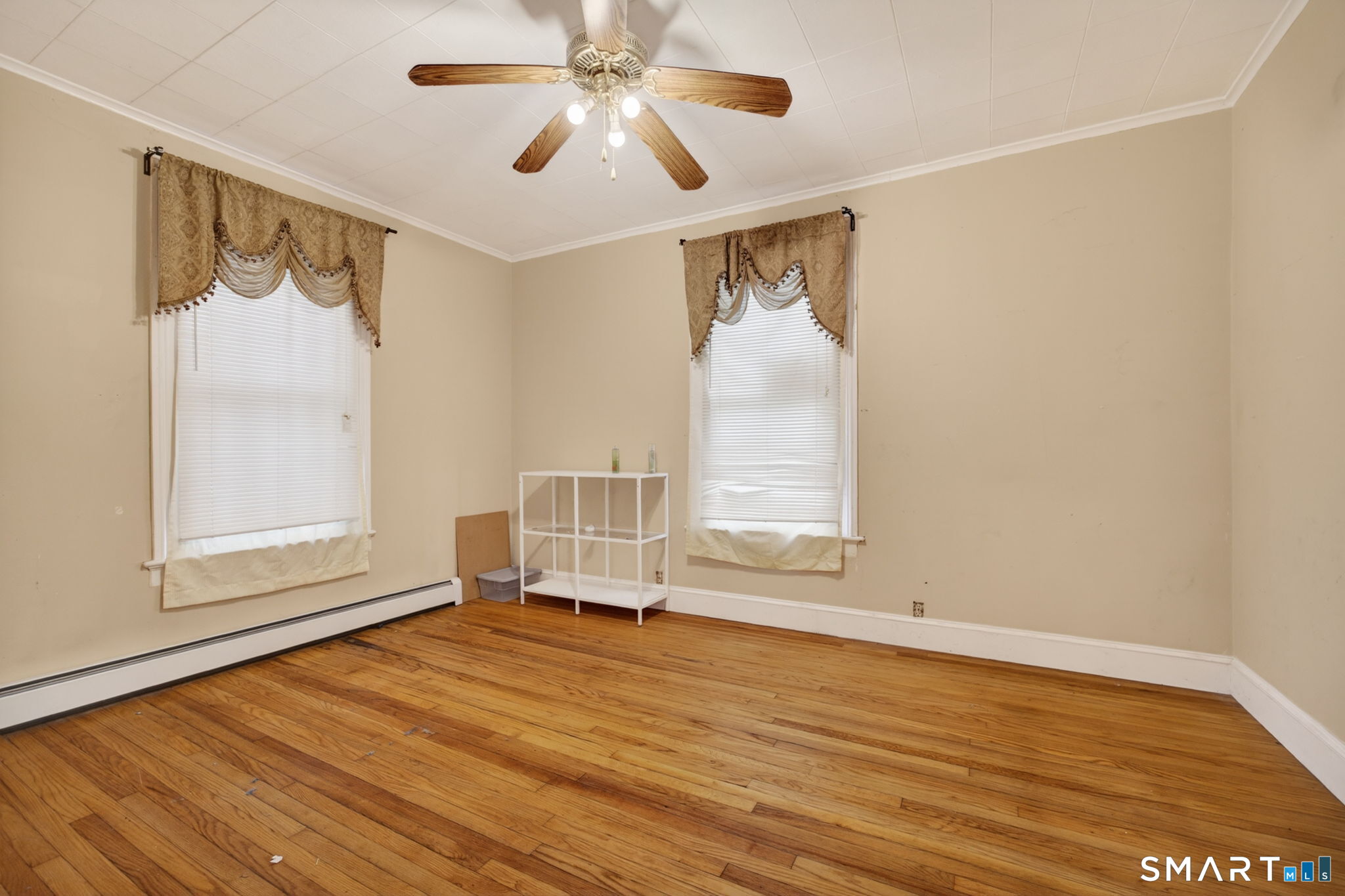 670 Hanover Road Meriden, CT 06451 - Photo 23 of 40 an empty room with wooden floor fan and windows
