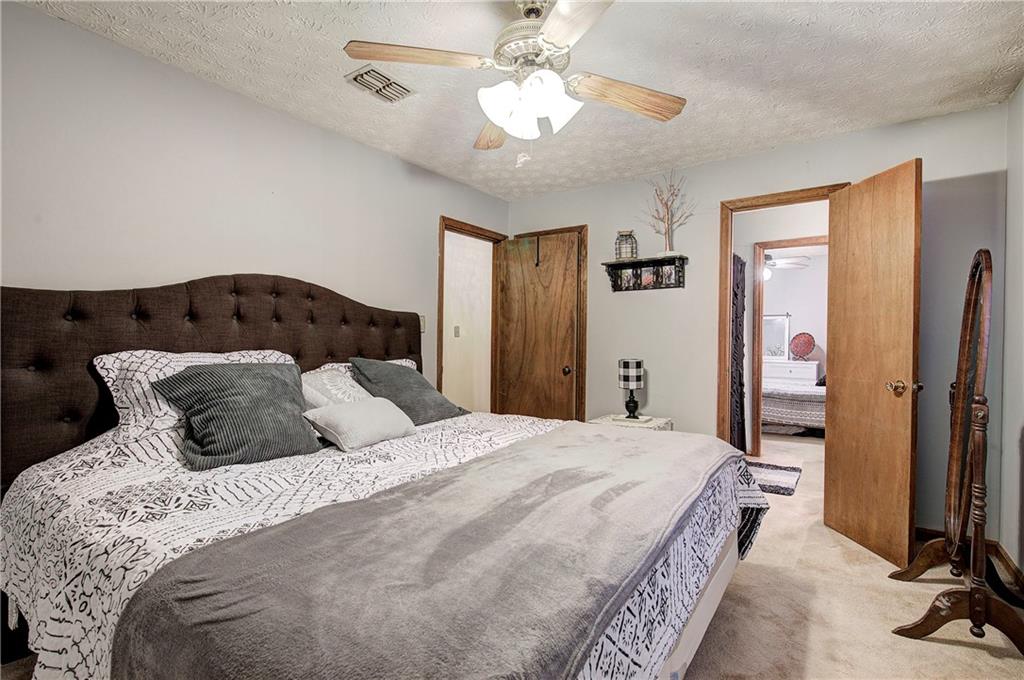 3637 Nebo Road Hiram, GA 30141 - Photo 50 of 63 a bedroom with a bed and a chandelier
