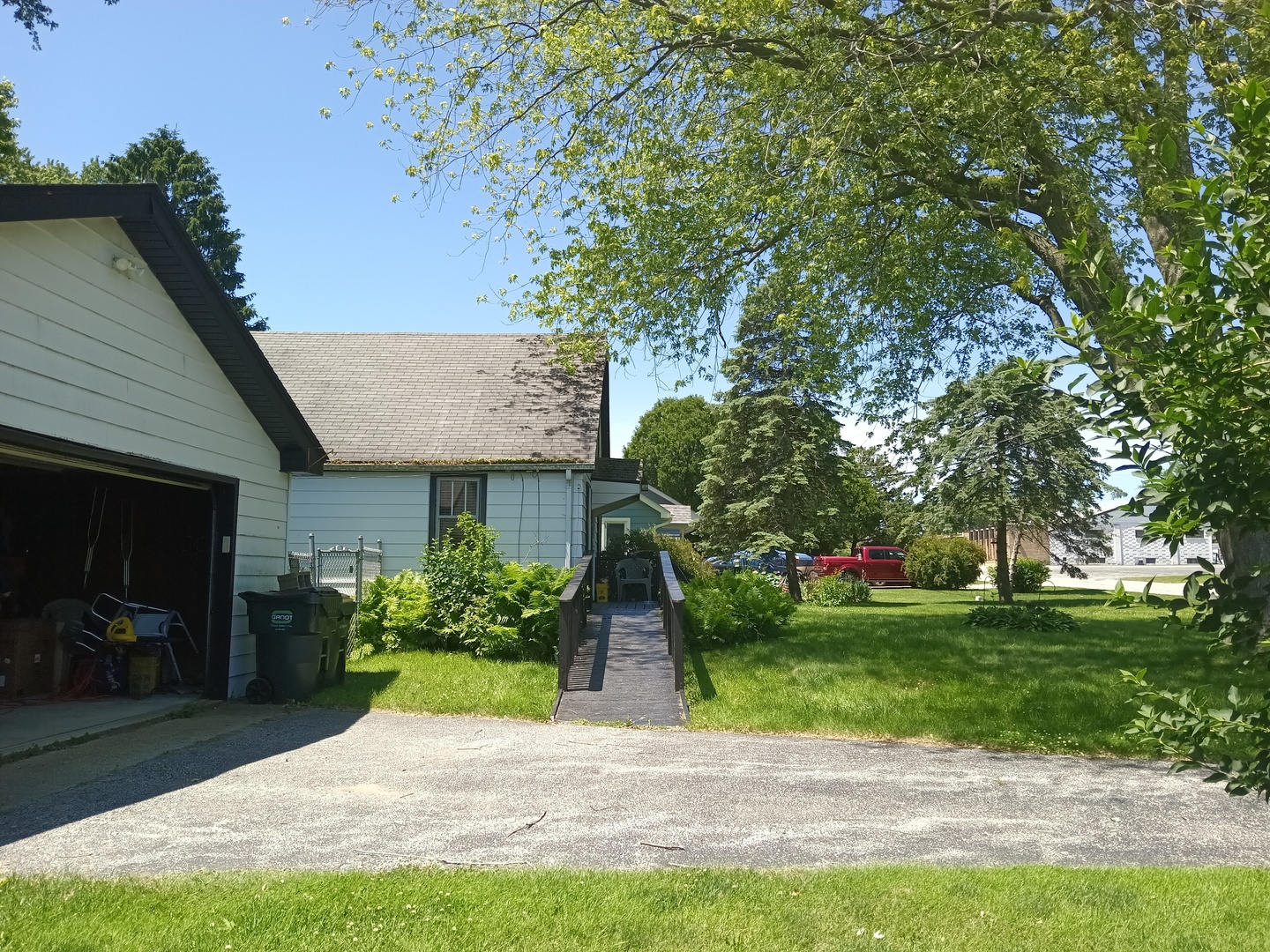 9867 17th Street Zion, IL 60099 - Photo 15 of 15 a front view of a house with a yard and potted plants