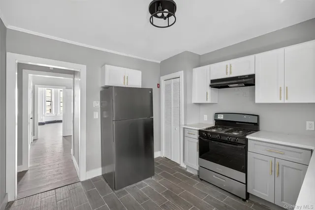a kitchen with a refrigerator and a stove