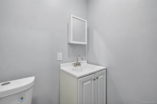 a bathroom with a sink toilet and mirror