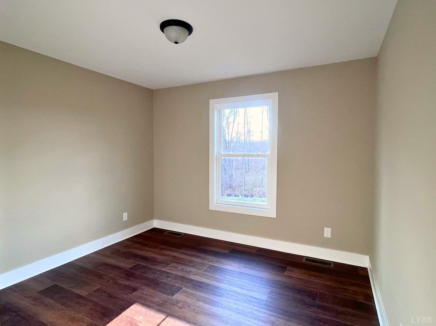 61 Luke Court Rustburg, VA 24588 - Photo 30 of 39 an empty room with wooden floor and windows