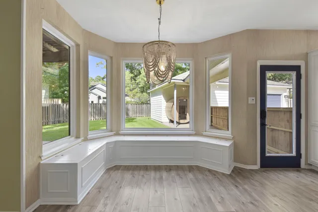 a kitchen with stainless steel appliances granite countertop a stove top oven a sink dishwasher and a refrigerator with wooden floor