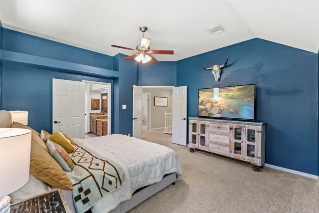 a view of a livingroom with a chandelier fan