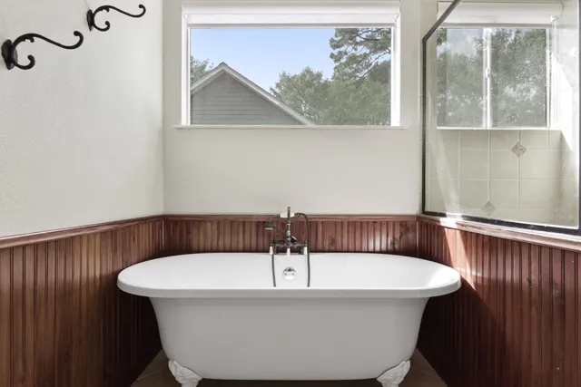 a spacious bathroom with a double vanity sink a mirror and a shower