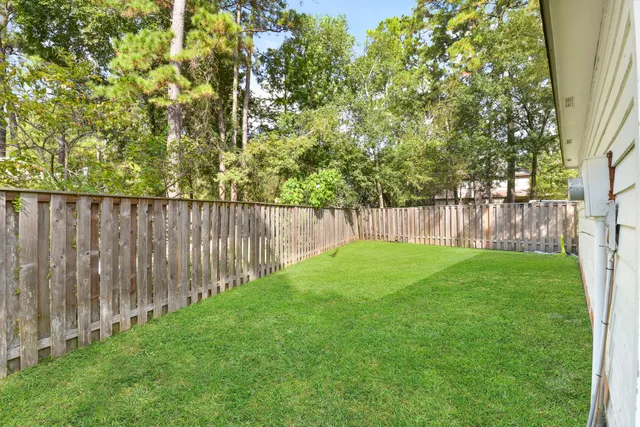a view of a house with a yard and sitting area