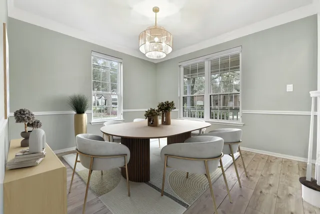 a view of a dining room with furniture wooden floor and a chandelier