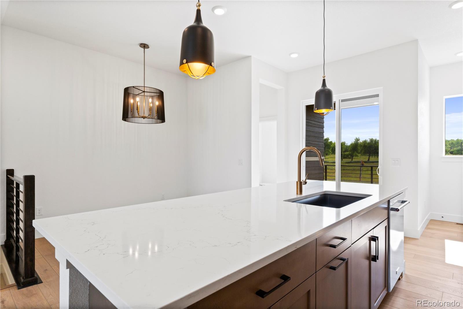 14241 Currant Street Broomfield, CO 80020 - Photo 12 of 25 a kitchen with a sink a stove and a wooden floor