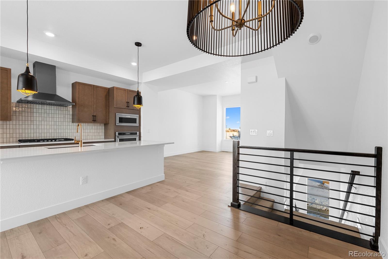 14241 Currant Street Broomfield, CO 80020 - Photo 16 of 25 a view of a kitchen with wooden floor and a sink