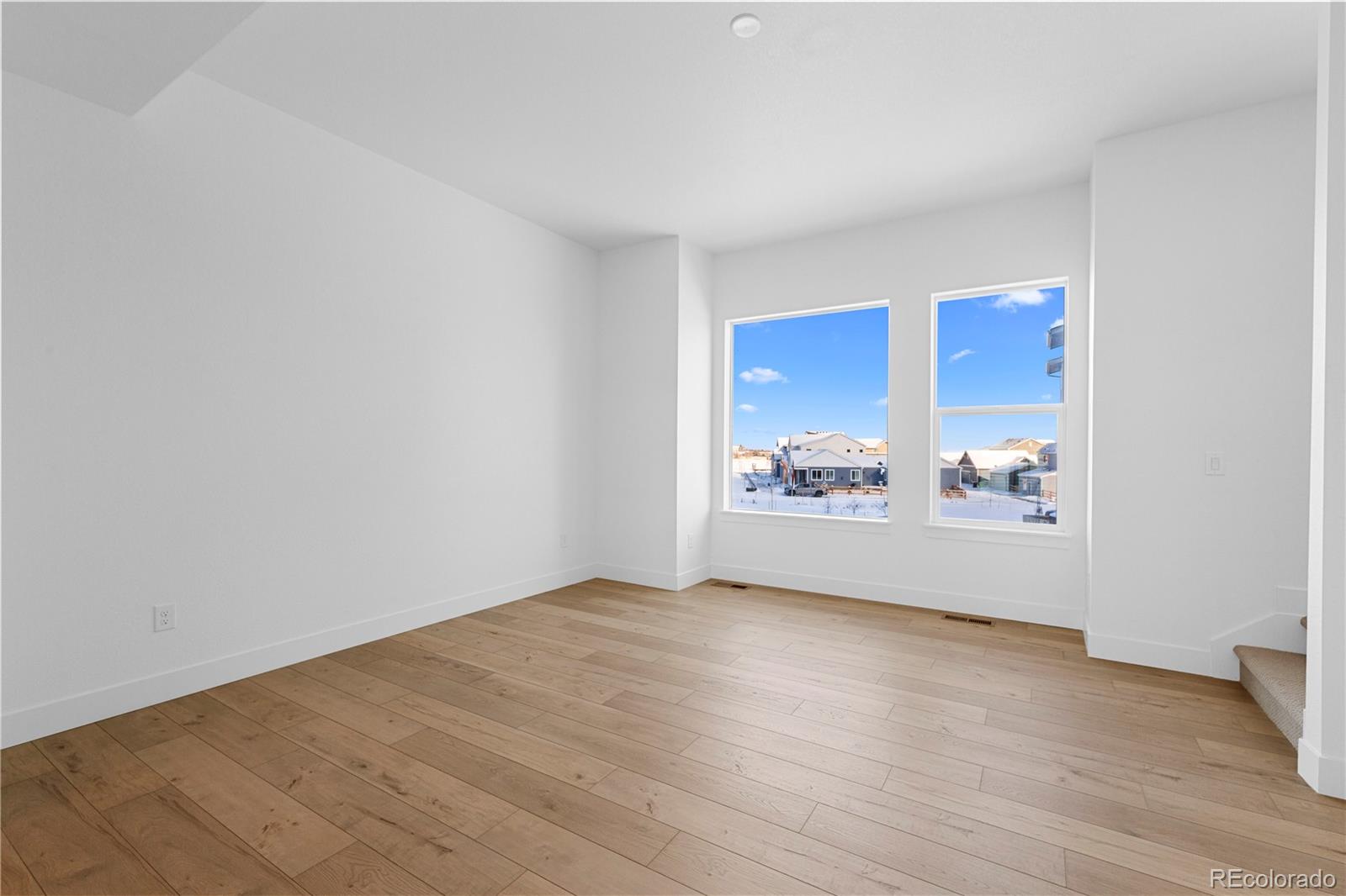 14241 Currant Street Broomfield, CO 80020 - Photo 17 of 25 an empty room with wooden floor and windows