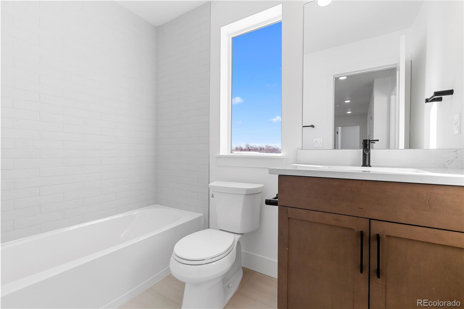 14241 Currant Street Broomfield, CO 80020 - Photo 23 of 25 a bathroom with a sink a toilet and shower