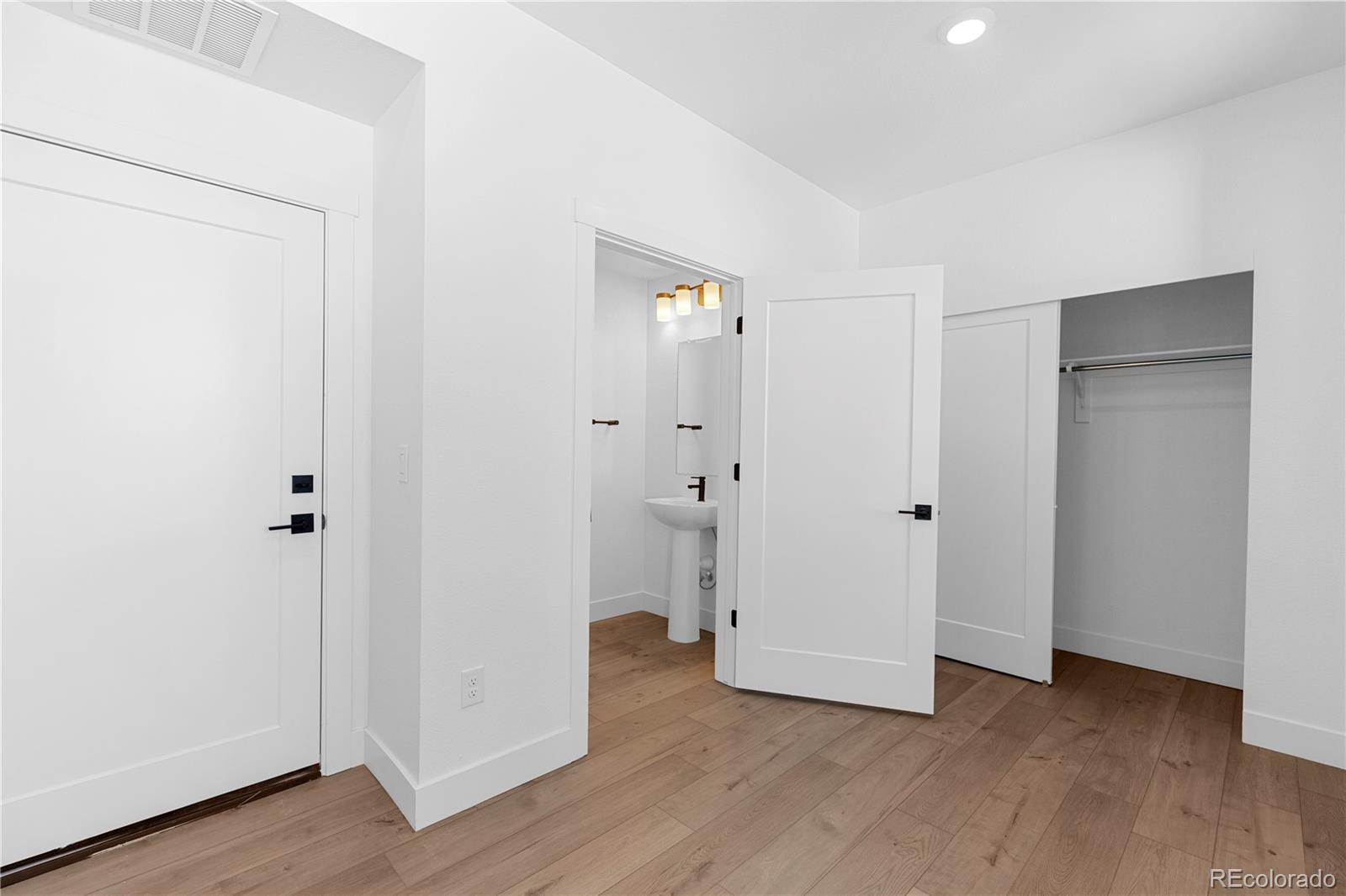 14241 Currant Street Broomfield, CO 80020 - Photo 7 of 25 a view of an empty room with wooden floor