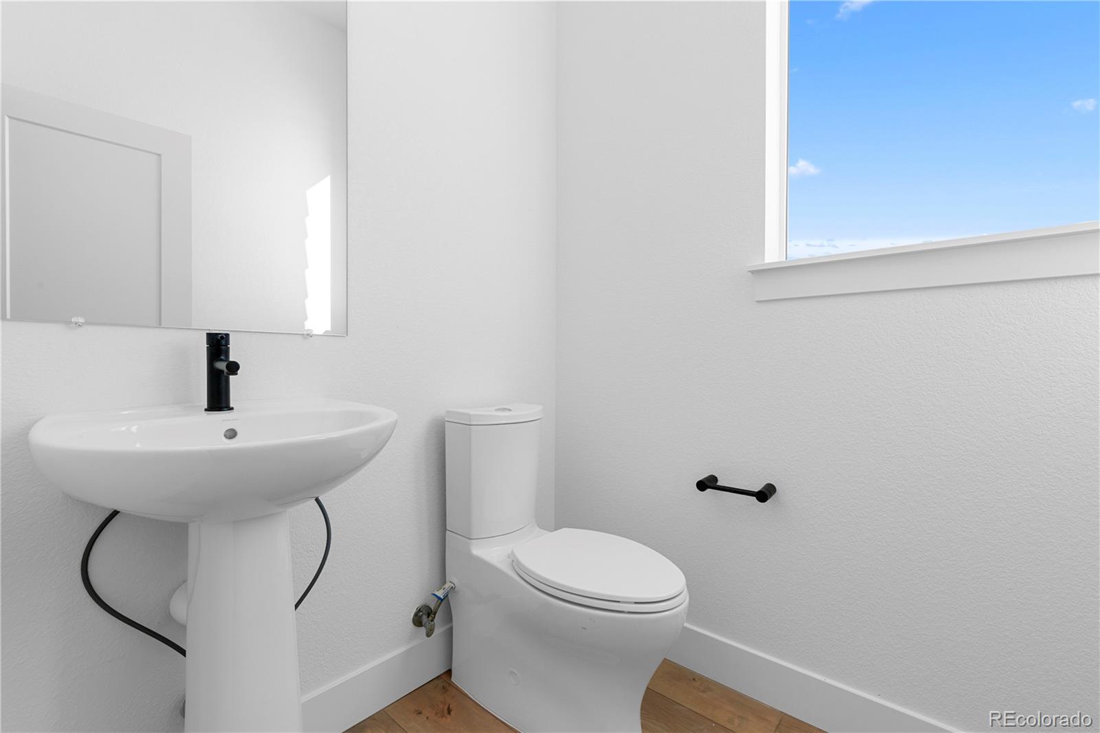 14241 Currant Street Broomfield, CO 80020 - Photo 9 of 25 a bathroom with a toilet sink and mirror