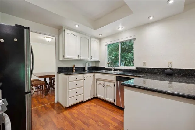 a kitchen with a sink window and cabinets