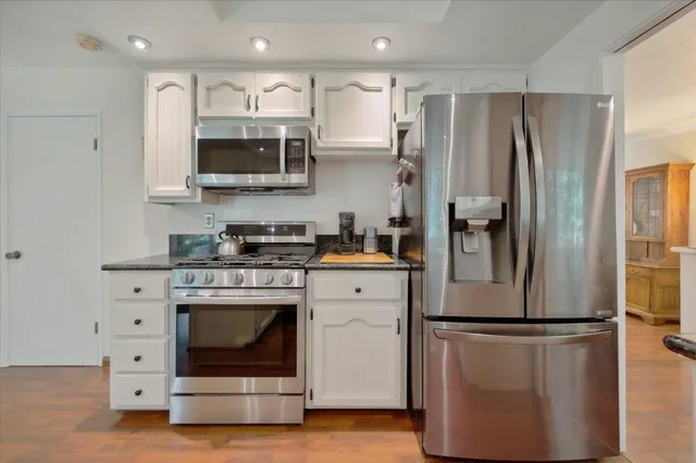 a kitchen with stainless steel appliances a refrigerator stove and microwave