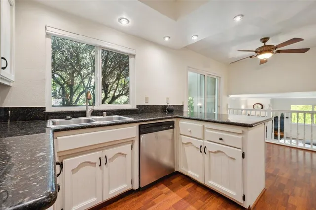 a kitchen with stainless steel appliances granite countertop a stove and a sink