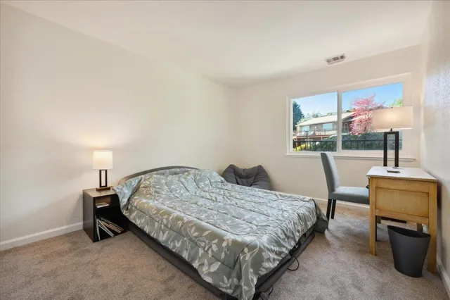 a bathroom with a granite countertop sink mirror and toilet