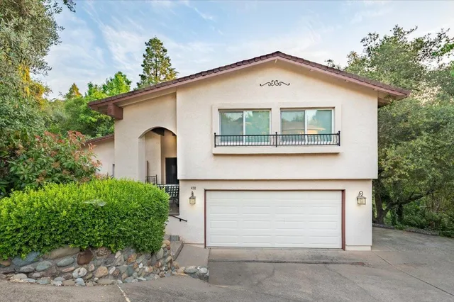 a view of a porch with a floor to ceiling window and potted plants
