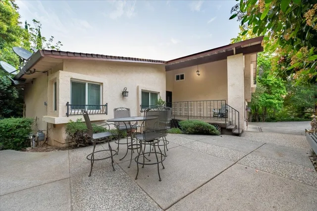 a view of a patio with table and chairs and potted plants