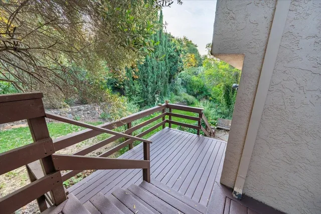 an aerial view of a house with a garden and lake view