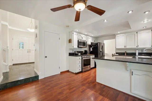 a kitchen with stainless steel appliances a refrigerator and a stove top oven