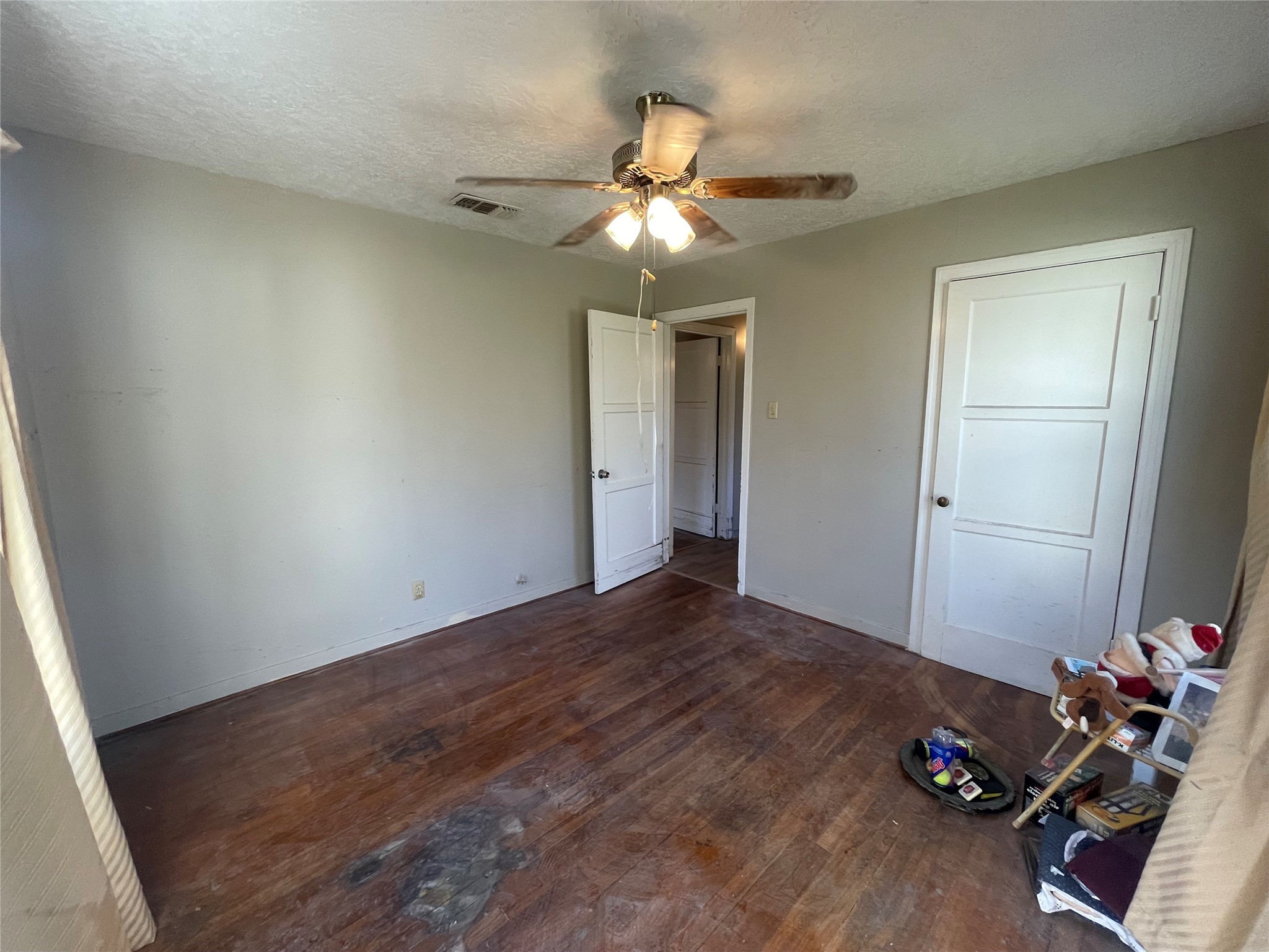 6642 Teluco Street Houston, TX 77055 - Photo 13 of 27 a view of a room with wooden floor and closet
