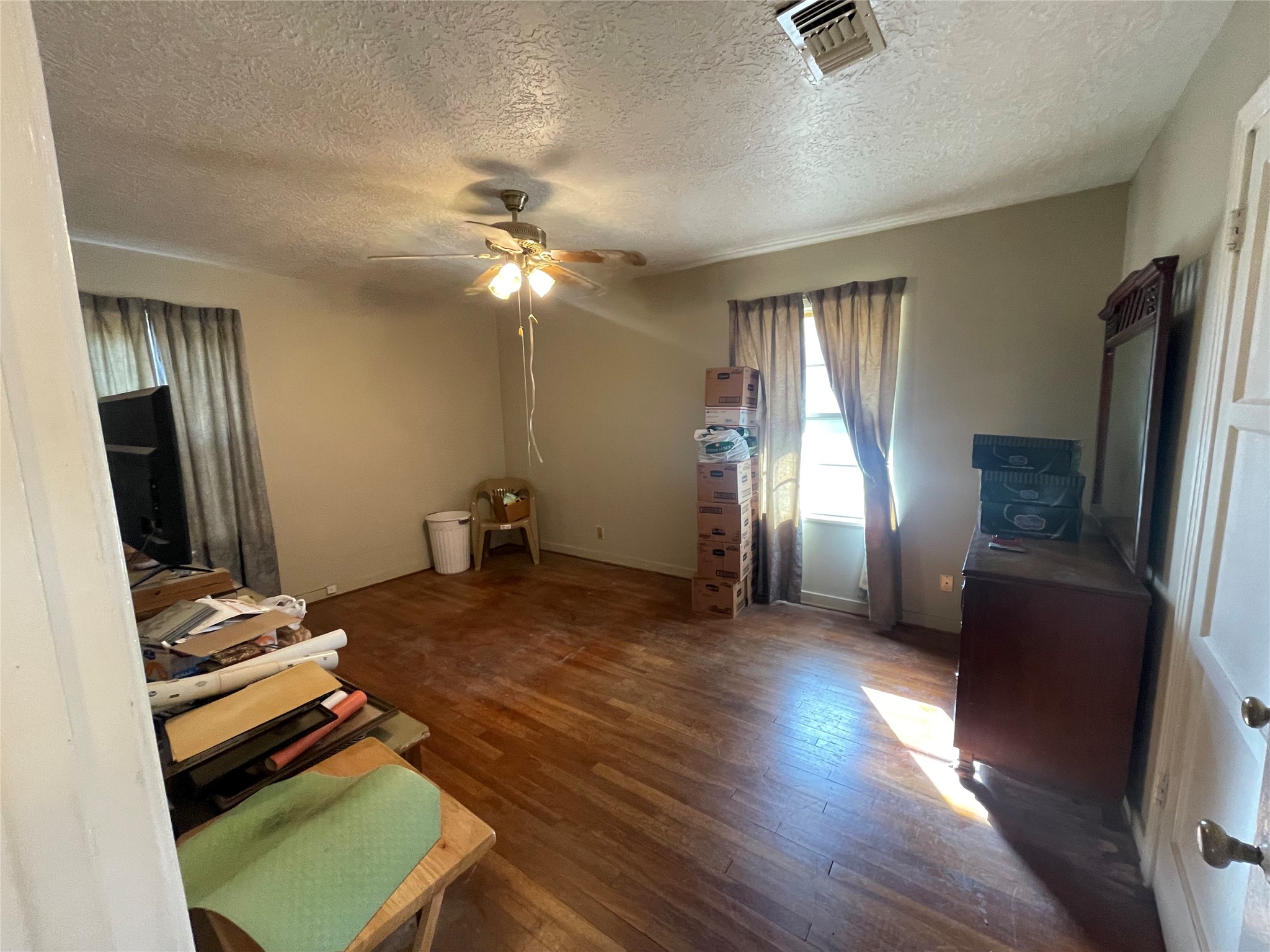 6642 Teluco Street Houston, TX 77055 - Photo 14 of 27 a bedroom with a bed and wooden floor