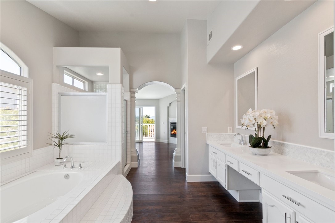 31895 Dane Court Temecula, CA 92591 - Photo 34 of 48 a bathroom with a double vanity sink a mirror and a bathtub
