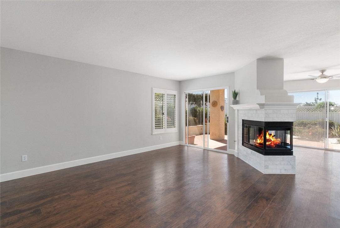 31895 Dane Court Temecula, CA 92591 - Photo 7 of 48 an empty room with wooden floor fire place and windows