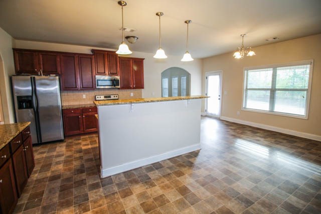 22 Riverside Drive Fort Mitchell, AL 36856 - Photo 8 of 28 a view of a kitchen with stainless steel appliances granite countertop a refrigerator a oven a sink with a dining table and chairs
