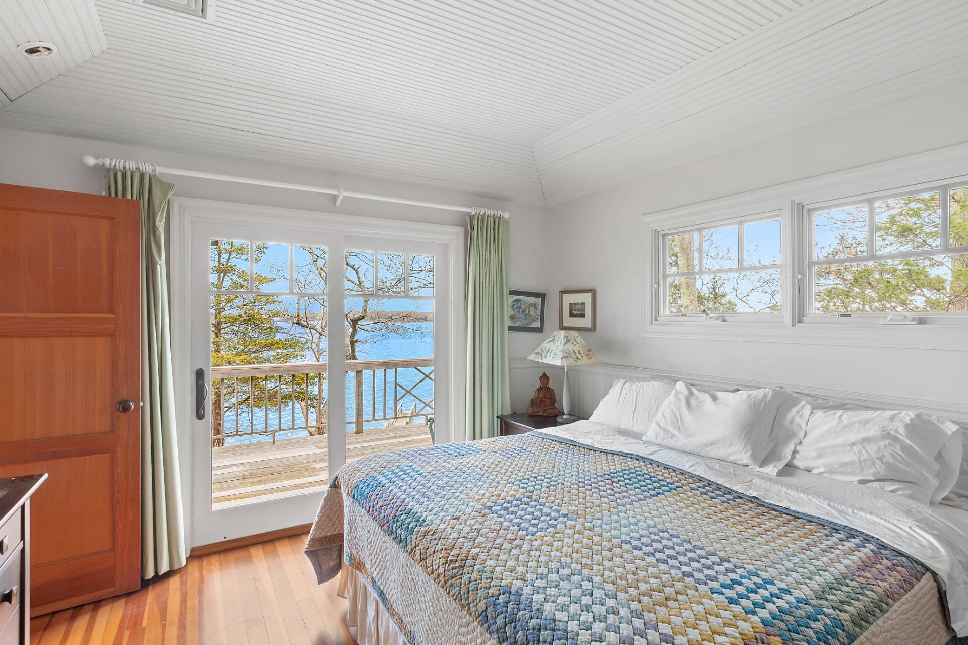 26 Duke Drive East Hampton, NY 11937 - Photo 14 of 20 a bedroom with a large bed and a large window