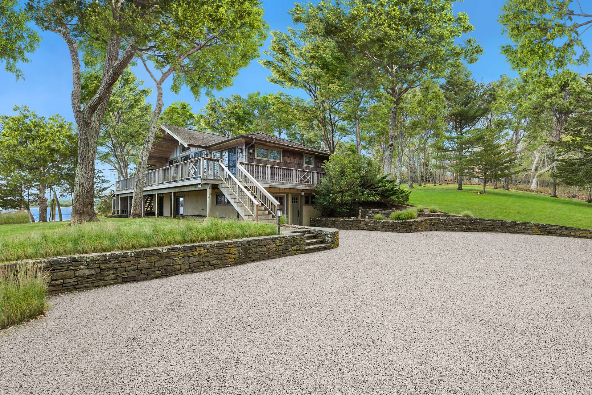 26 Duke Drive East Hampton, NY 11937 - Photo 16 of 20 a front view of a house with a yard