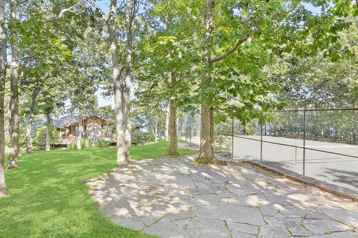 26 Duke Drive East Hampton, NY 11937 - Photo 17 of 20 a view of a yard with large trees