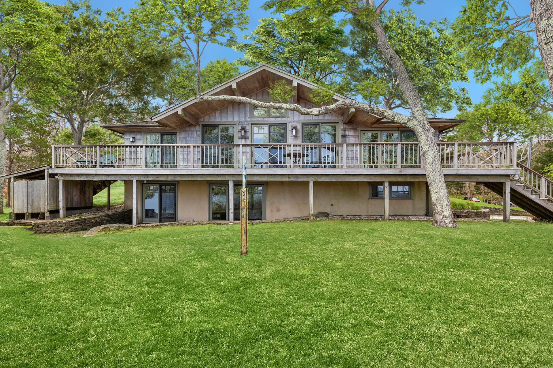 26 Duke Drive East Hampton, NY 11937 - Photo 4 of 20 a front view of a house with a garden