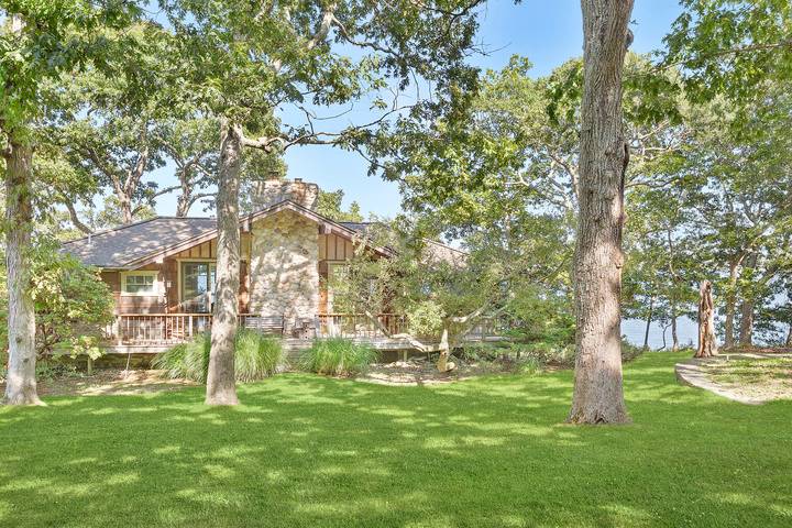 26 Duke Drive East Hampton, NY 11937 - Photo 5 of 20 a garden with trees in the background