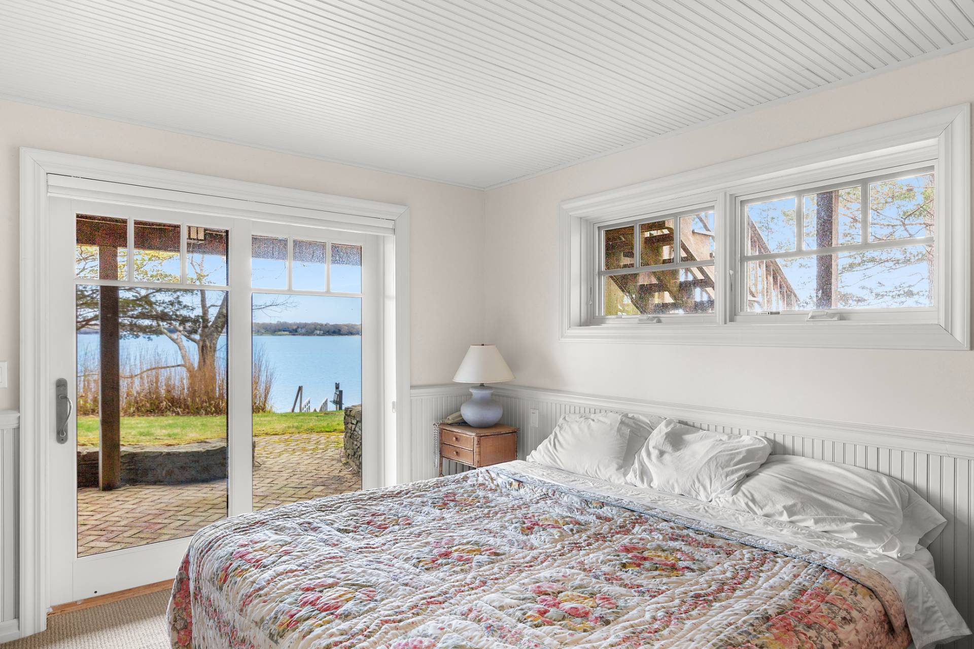 26 Duke Drive East Hampton, NY 11937 - Photo 10 of 20 a bedroom with a large bed and a large window